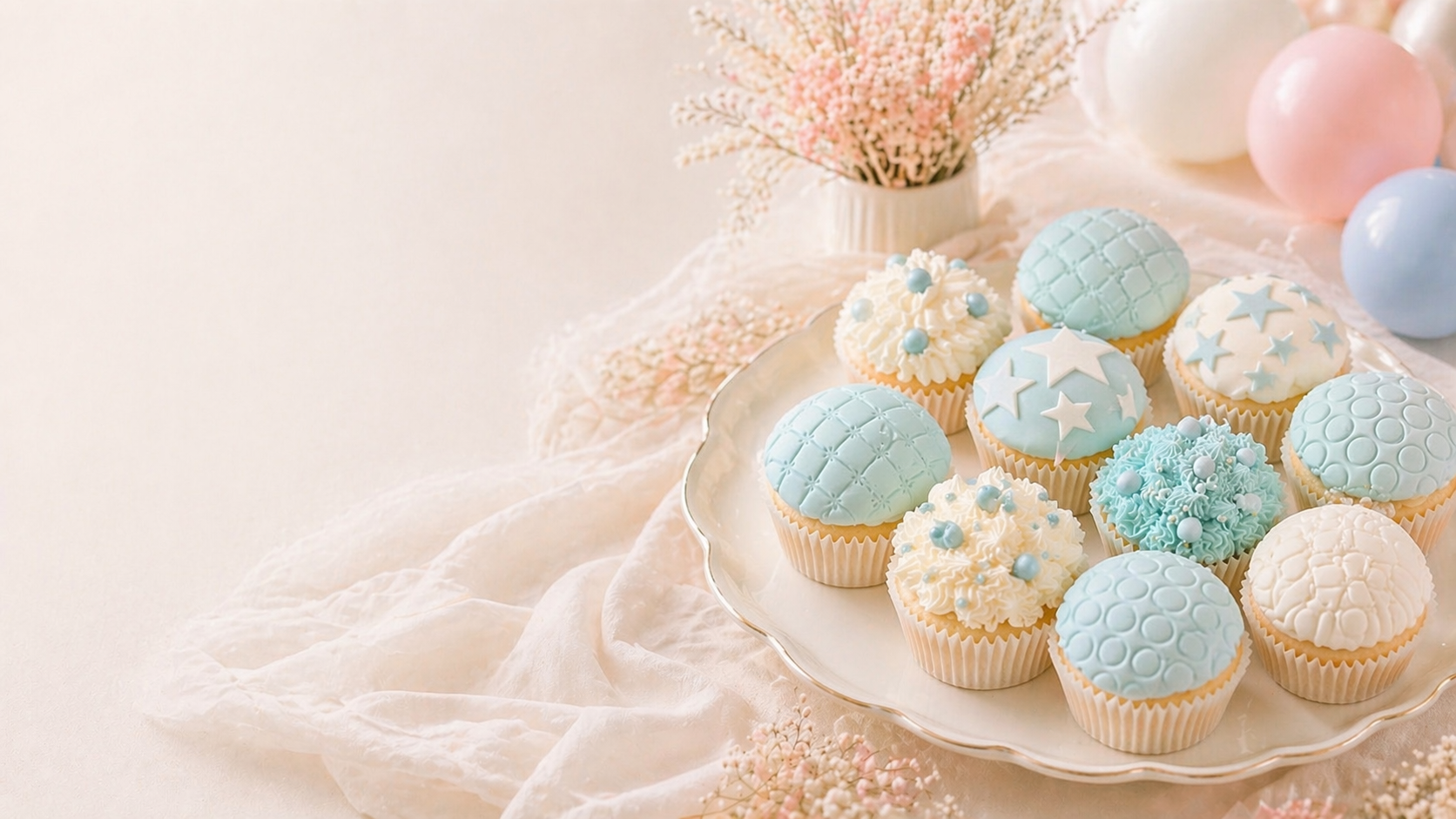 Styled baby shower dessert table with fondant cupcakes in powder blue and ivory, teddy bear cake and organic balloon garland by Little Moment Studio Kent